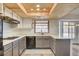 Charming kitchen featuring wood ceiling accent, stainless appliances, neutral counters and cabinetry at 7417 Radville Dr, Las Vegas, NV 89129