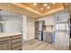Open kitchen with stainless steel appliances, wood flooring, and access to adjacent living and dining rooms at 7417 Radville Dr, Las Vegas, NV 89129