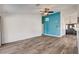 Spacious living room with an accent wall, wood floors, and neutral decor at 7417 Radville Dr, Las Vegas, NV 89129