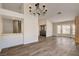 Bright living room with wood floors, a chandelier, and a large bay window at 7417 Radville Dr, Las Vegas, NV 89129