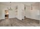 Bright living room featuring modern gray wood flooring and stylish light fixtures at 7417 Radville Dr, Las Vegas, NV 89129