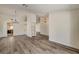 Bright living room featuring modern gray wood flooring and stylish light fixtures at 7417 Radville Dr, Las Vegas, NV 89129