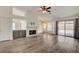 Open living room with fireplace, wood floors, and sliding glass doors at 7417 Radville Dr, Las Vegas, NV 89129