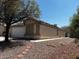Exterior view of house with front rock yard and stepping stone walkway leading to the front entrance at 7850 Flagler St, Las Vegas, NV 89139