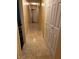 Hallway features tile flooring, storage closet, and neutral paint, connecting different areas of the home at 7850 Flagler St, Las Vegas, NV 89139