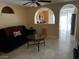 Living room features tile floor, arched entryway and couch at 7850 Flagler St, Las Vegas, NV 89139