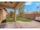 Inviting backyard featuring an entertainment space, synthetic grass, and a charming privacy fence at 7937 Granite Walk Ave, Las Vegas, NV 89178