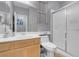 Bathroom with single vanity, a sliding glass door shower, toilet, and large mirror at 7937 Granite Walk Ave, Las Vegas, NV 89178