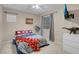 Bright bedroom with a ceiling fan, mounted TV, and window for natural light at 7937 Granite Walk Ave, Las Vegas, NV 89178