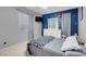 bedroom featuring creative blue accent wall and carpeted floors at 7937 Granite Walk Ave, Las Vegas, NV 89178