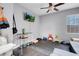 Neutral bonus room with gray walls, ceiling fan, window, TV, and space for exercise equipment at 7937 Granite Walk Ave, Las Vegas, NV 89178
