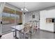 Dining area with sliding glass doors to the patio, a decorative chandelier and view of the kitchen at 7937 Granite Walk Ave, Las Vegas, NV 89178