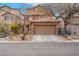Two-story home with a two-car garage and low-maintenance desert landscaping at 7937 Granite Walk Ave, Las Vegas, NV 89178