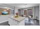 Open kitchen and dining area featuring dark wood floors and contemporary furnishings at 7937 Granite Walk Ave, Las Vegas, NV 89178