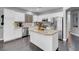 Bright kitchen with white cabinets, a granite island, and stainless steel appliances at 7937 Granite Walk Ave, Las Vegas, NV 89178