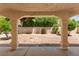 Covered patio with decorative columns overlooks a landscaped backyard at 8934 Pomona Ct, Las Vegas, NV 89147