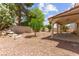 Large backyard with decorative rock, landscaping, and covered patio at 8934 Pomona Ct, Las Vegas, NV 89147