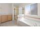 Bright bathroom featuring a bathtub and shower with bright tiles at 8934 Pomona Ct, Las Vegas, NV 89147