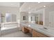 Bathroom featuring dual sinks, bathtub, and a shower, offering a relaxing spa-like experience at 8934 Pomona Ct, Las Vegas, NV 89147
