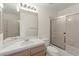 Cozy bathroom with tile countertop, single sink, and tub-shower combo at 8934 Pomona Ct, Las Vegas, NV 89147