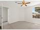 Bedroom with carpet flooring, neutral paint, a window, and a ceiling fan at 8934 Pomona Ct, Las Vegas, NV 89147
