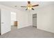 Bright bedroom with carpet flooring, a ceiling fan, and a sliding door closet at 8934 Pomona Ct, Las Vegas, NV 89147