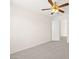 Bright bedroom with neutral walls, carpet flooring, and a ceiling fan at 8934 Pomona Ct, Las Vegas, NV 89147