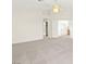 Bright bedroom featuring neutral carpet, large windows, and a modern ceiling fan at 8934 Pomona Ct, Las Vegas, NV 89147