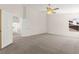 Spacious bedroom features neutral carpet, ceiling fan, and ample natural light from the large window at 8934 Pomona Ct, Las Vegas, NV 89147