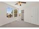 Bright bedroom with carpet flooring, a ceiling fan, and a sliding door closet at 8934 Pomona Ct, Las Vegas, NV 89147