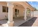 Charming covered patio with substantial pillars, providing shade and an inviting outdoor living area at 8934 Pomona Ct, Las Vegas, NV 89147