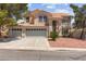Elegant two-story home with a three-car garage, tiled roof, and manicured landscaping, perfect for families at 8934 Pomona Ct, Las Vegas, NV 89147