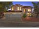 Elegant two-story home with a three-car garage, tiled roof, and manicured landscaping, perfect for families at 8934 Pomona Ct, Las Vegas, NV 89147