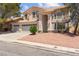 Inviting two-story home with manicured landscaping and a three-car garage on a sunny day at 8934 Pomona Ct, Las Vegas, NV 89147