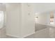 Hallway area leading to carpeted room, with tile flooring and neutral paint, bathed in natural light at 8934 Pomona Ct, Las Vegas, NV 89147