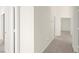 Inviting hallway featuring carpet and white walls, offering a clear path through the home at 8934 Pomona Ct, Las Vegas, NV 89147