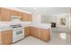 Well-lit kitchen with an oven and a view to the living room with a fireplace at 8934 Pomona Ct, Las Vegas, NV 89147