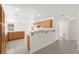 Bright kitchen featuring tile flooring, wood cabinetry, and counter seating at 8934 Pomona Ct, Las Vegas, NV 89147