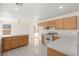 Open-concept kitchen with tile flooring, white appliances and wood cabinetry at 8934 Pomona Ct, Las Vegas, NV 89147
