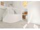 Spacious living area featuring staircase, chandelier, plush carpet, and open access to a modern kitchen at 8934 Pomona Ct, Las Vegas, NV 89147