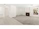 Open living room with fireplace, carpet flooring, and bright white walls at 8934 Pomona Ct, Las Vegas, NV 89147