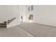 Bright living room with staircase, plush carpet, tile entry, and large windows offering plenty of natural light at 8934 Pomona Ct, Las Vegas, NV 89147