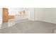 Living room with carpet and tile flooring leading to the kitchen at 8934 Pomona Ct, Las Vegas, NV 89147