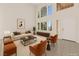 Bright living room with soaring ceilings, large windows, and contemporary furnishings, perfect for entertaining at 8934 Pomona Ct, Las Vegas, NV 89147