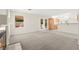 Comfortable living room with fireplace, kitchen access, and backyard view through glass doors at 8934 Pomona Ct, Las Vegas, NV 89147