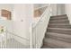 Carpeted staircase featuring white railing and high ceilings at 8934 Pomona Ct, Las Vegas, NV 89147
