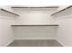 Well-organized walk-in closet with multiple shelves and hanging rods for ample storage at 8934 Pomona Ct, Las Vegas, NV 89147
