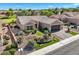 Charming home showcasing meticulous landscaping, desert accents, lush turf, and a paver driveway at 10013 Hunter Springs Dr, Las Vegas, NV 89134