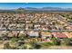 Sweeping aerial view capturing a serene neighborhood with diverse homes and distant mountain silhouettes at 10013 Hunter Springs Dr, Las Vegas, NV 89134