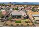 Stunning aerial shot showcasing a lovely home, fenced yard, manicured lawn, and mountain views at 10013 Hunter Springs Dr, Las Vegas, NV 89134